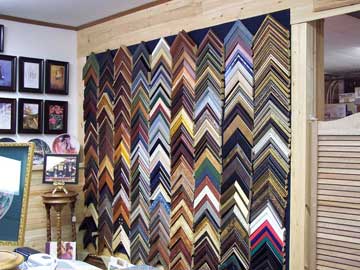 Wall of framing samples at Witt's Custom Framing — hundreds of frame choices